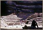 Photographer Prepares To Film Amphitheater At Petra From Cavern